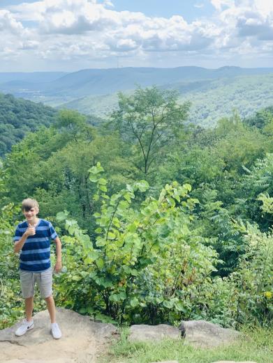 A boy gives a thumbs-up from a scenic overlook in Monte Sano State Park.