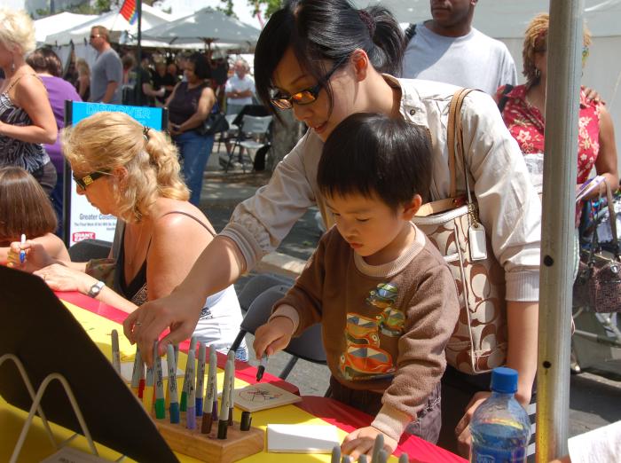 Mother and young son taking part in hands-on crafts at the Columbus Arts Festival