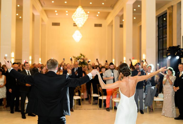Bride and Groom standing in front of a room full of guests at the Arbor Midtown venue in downtown Rochester.