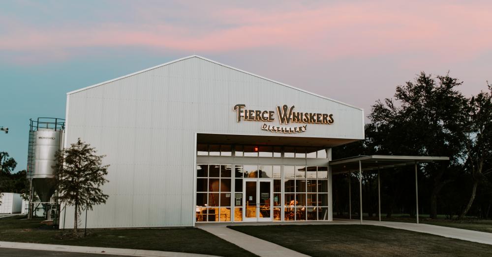 Exterior of Fierce Whiskers tasting room at sunset, surrounded by Hill Country