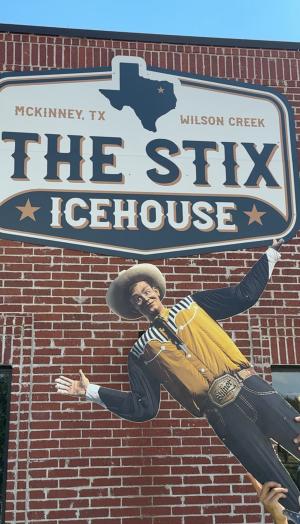 Cut out of Big Tex in front of The Stix Ice House sign.