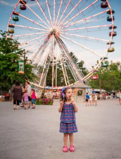 Girl eating ice cream cone Infront of Knoebels Ferris Wheel