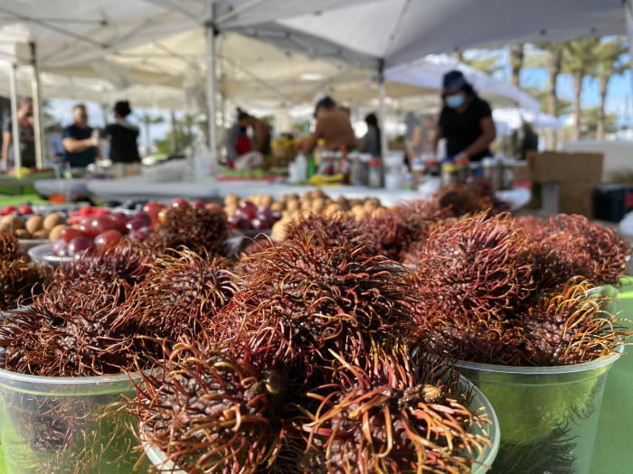 Exotic produce like these rambutans sit on a stand at the Las Olas Farmers Market.