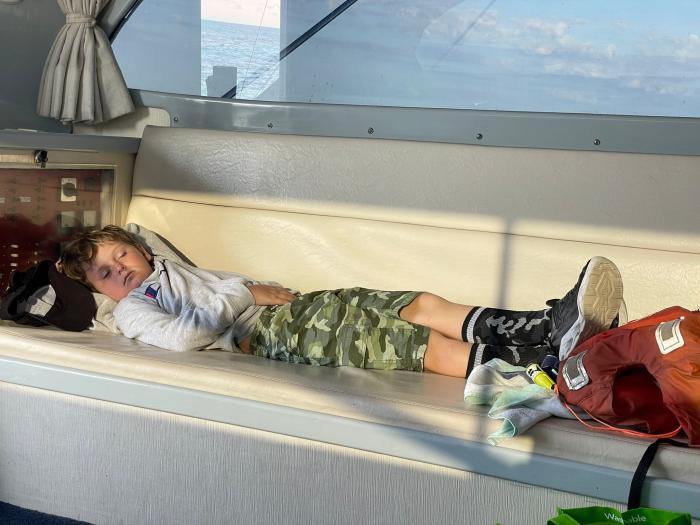 Boy Sleeping On A Fishing Charter Boat On The Outer Banks