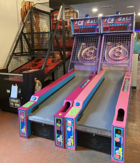 A basketball game and skee ball at an arcade