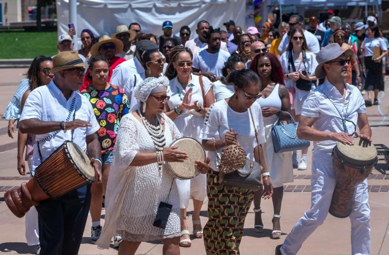 At Civic Plaza in Downtown Albuquerque, drummers lead a procession of people during the opening ceremony for the Juneteenth celebration during 2024 Juneteenth.