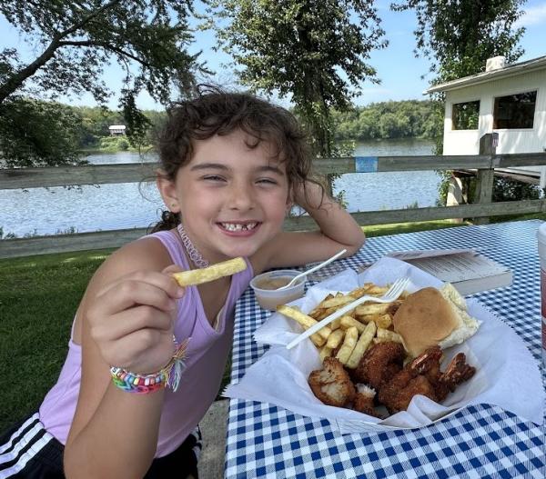 Picture of girl eating yummy food at the fence