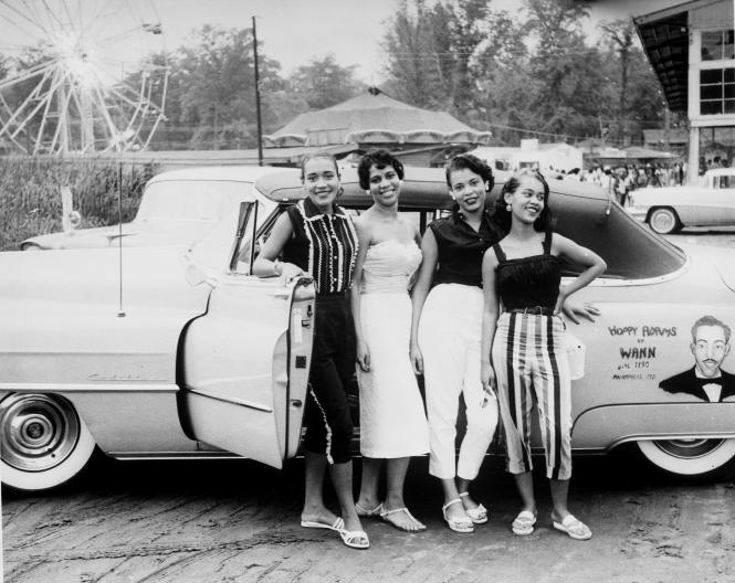 Carr's Beach, four women in front of Hoppy Adam's  car.