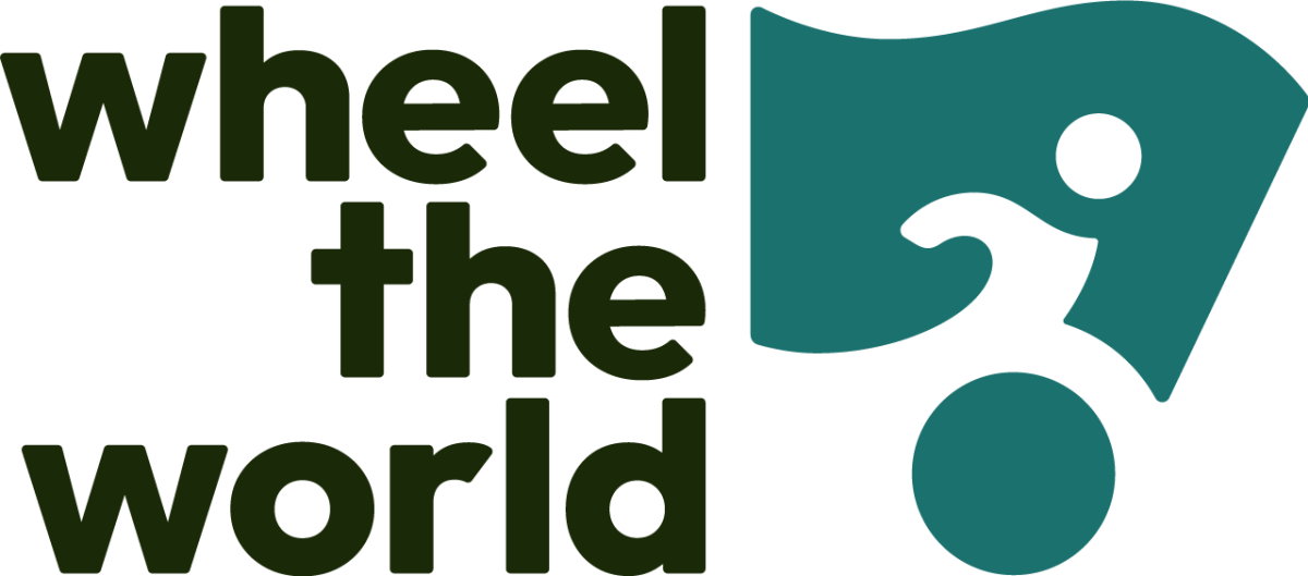 Wheel the World Logo in bold black print with outline of a wheel chair user to the right side of the text.