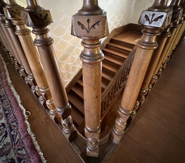 The main staircase in The Clayton House, Fort Smith, Arkansas, features ornately carved balusters.