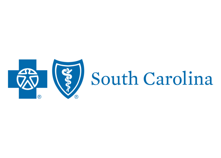 Blue Cross Blue Shield of South Carolina logo featuring two symbols: a blue cross with a human figure inside on the left, and a blue shield with a white caduceus (snake wrapped around a staff) on the right. To the right of the icons is the text “South Carolina” in blue font on a white background.
