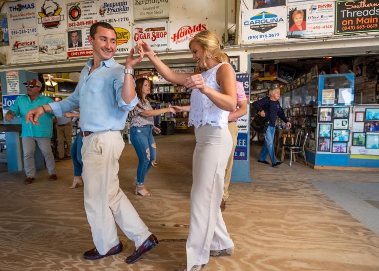 2 shaggers dancing in front of a crowd.