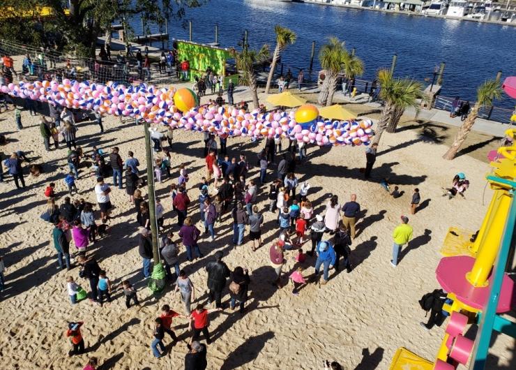 People enjoying themselves on teh beach at Lulu's at Barefoot Landing