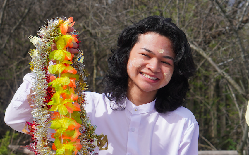 person smiling holding a lei
