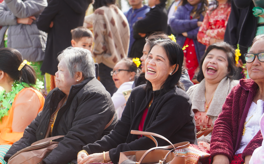 Women sitting in a crowd at an event