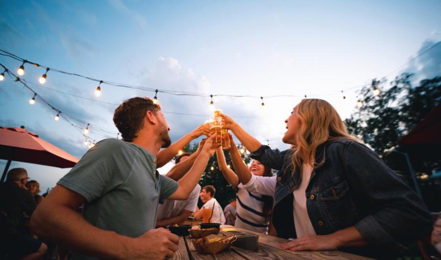 Group toasting at outdoor dining table