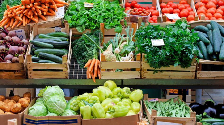 bins of a variety of vegetables at a farmers market