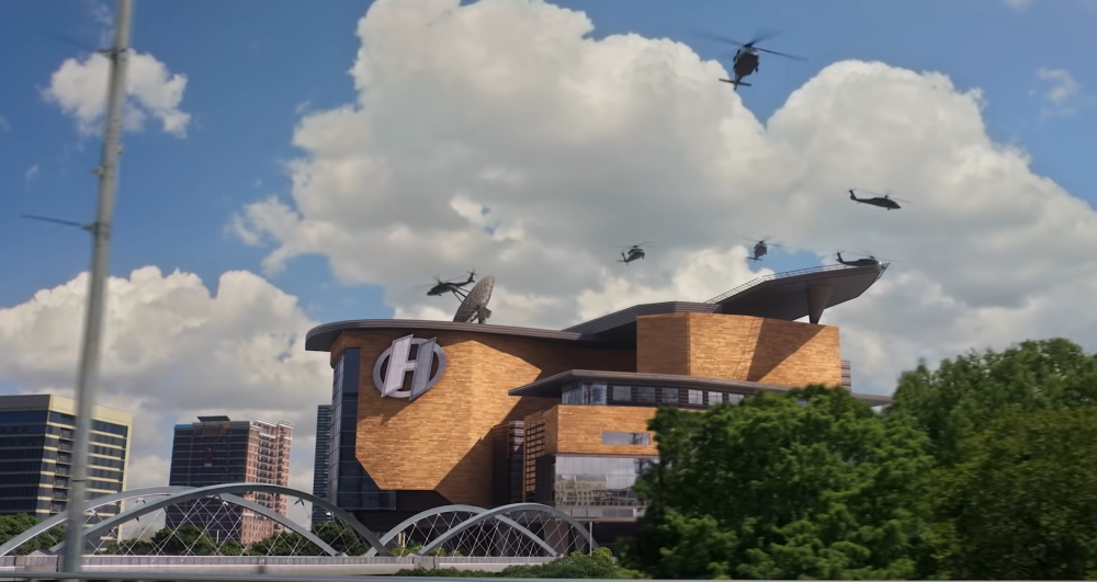 We Can Be Heroes screengrab showing helicopters flying over the Heroes Headquarters. Large white clouds dot the blue sky