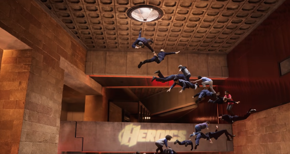 We Can Be Heroes screengrab with kids floating towards the ceiling inside the Heroes Headquarters Interior. The word Heroes is visible on the wall