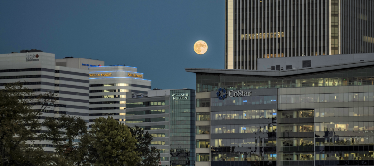 View of the moon through buildings