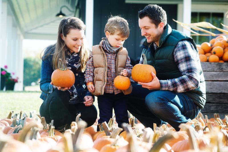 A family selecting the perfect pumpkin at the Pick-n-Patch