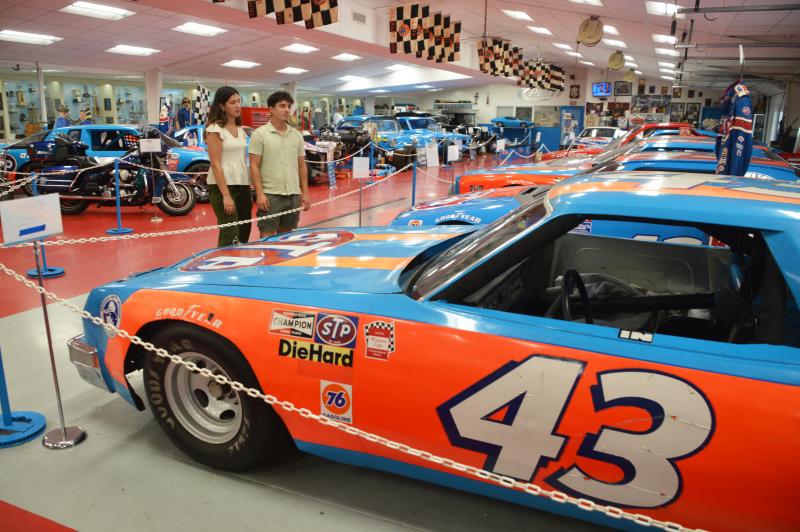 Couple exploring the car collection at the Petty Museum in Randleman, NC