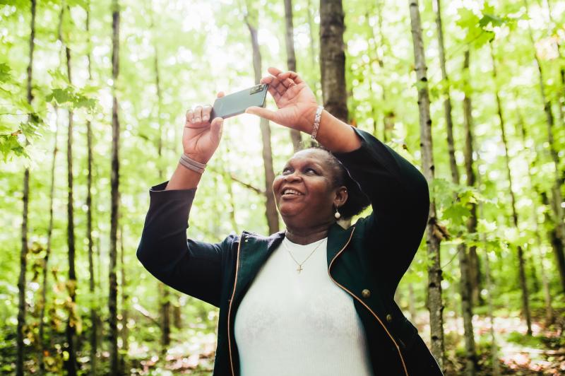 woman taking photo on trail