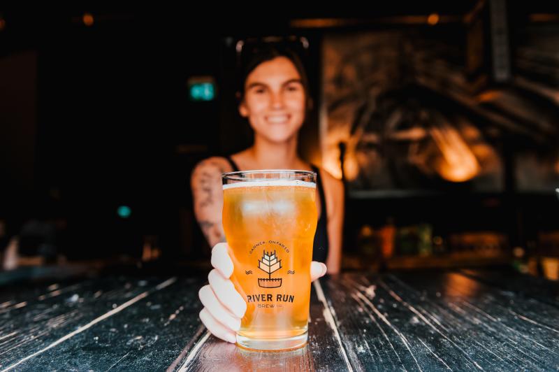 woman serving pint of beer