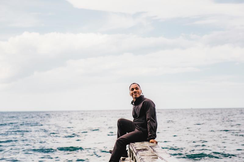 man sitting on pier