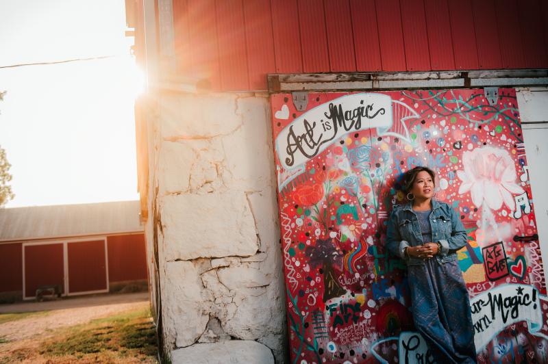 woman standing in front of mural