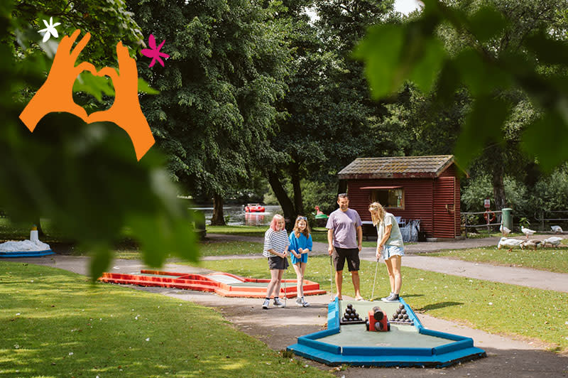 A family playing crazy golf.