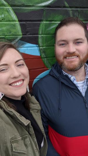 A man and a woman smiling at the camera.