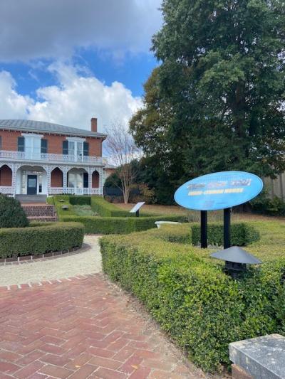 An external shot of the Ware-Lyndon House Museum showing a signpost for the African American Heritage Pathway.