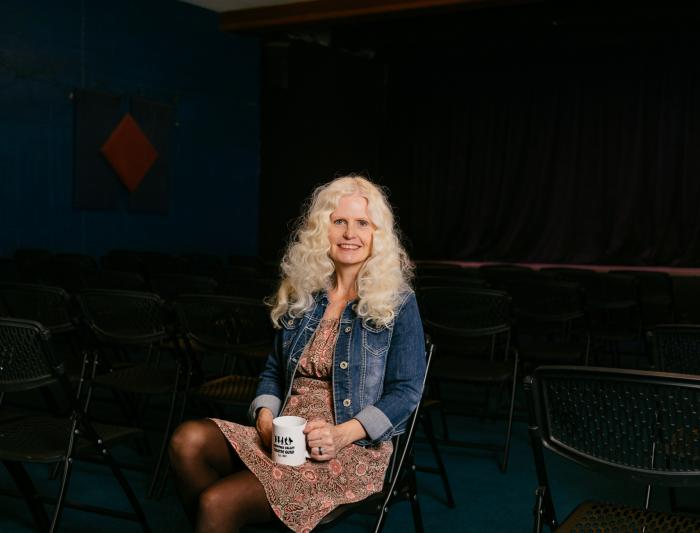 Ann Sessions sitting in a theatre