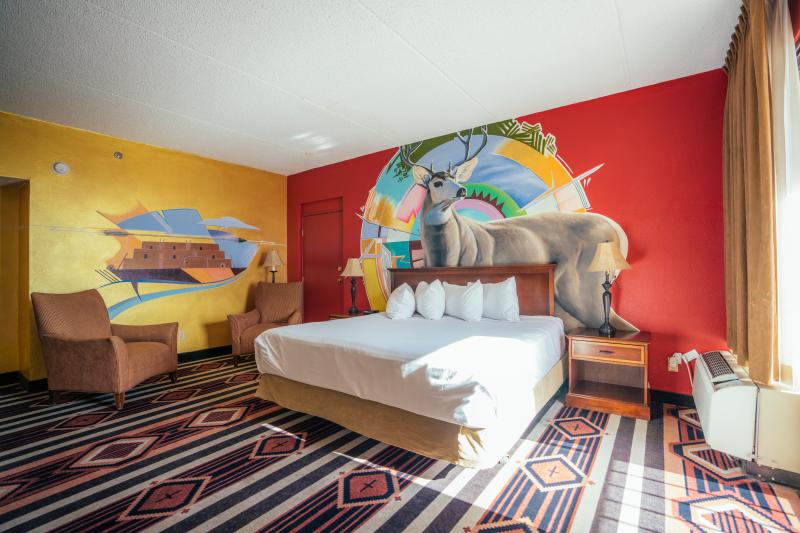 A picture of the inside of a room at Nativo Lodge featuring a colorful mural