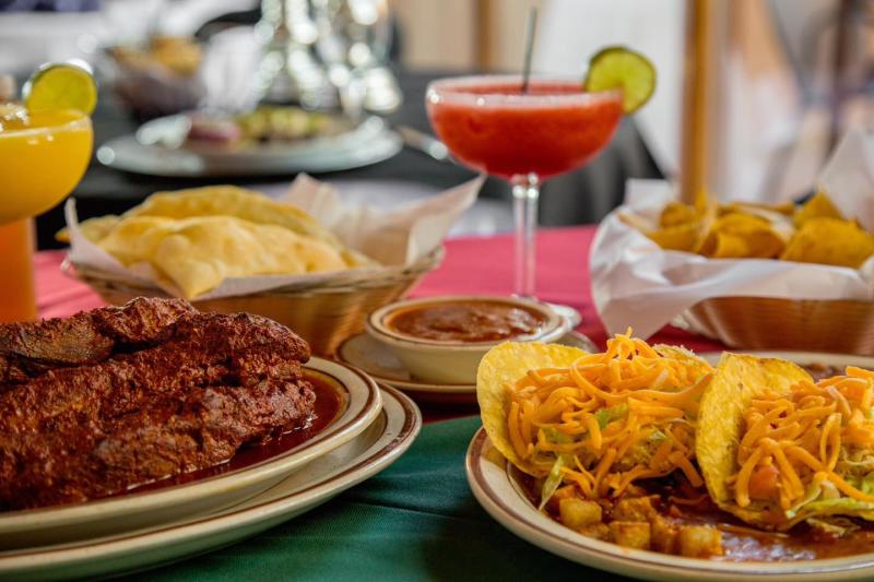 A table with tacos, ribs, chips and salsa, sopapillas and margaritas at Sadie's.