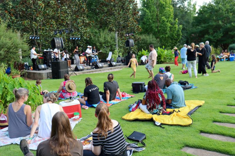 People sitting on picnic blankets and enjoying the Sunflower Concert Series