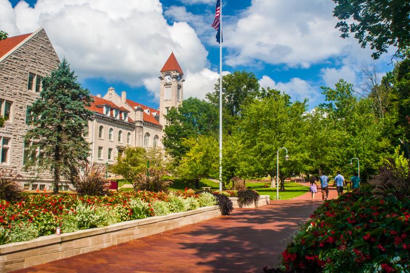 Group of students strolling on a the brick path at the IU campus