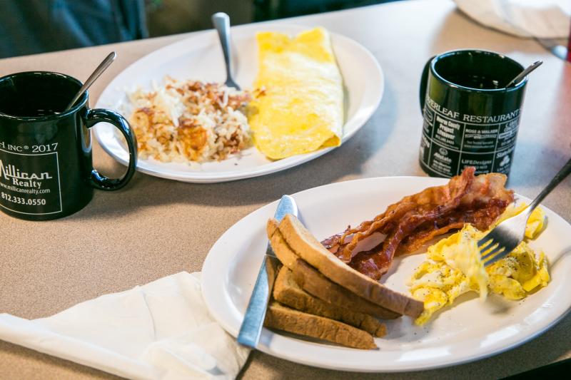 An omelet dish and a bacon-eggs-and-toast dish from Cloverleaf