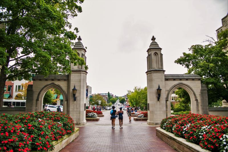 Two women walking through Sample Gates to Kirkwood Avenue