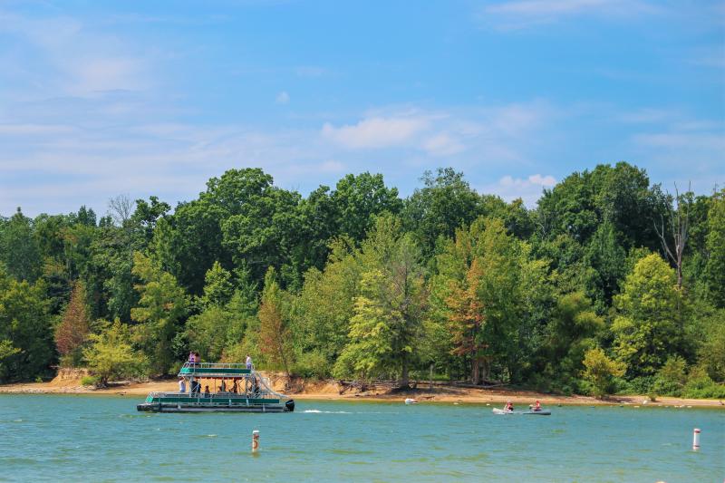 A pontoon and two kayaks on Monroe Lake at the Paynetown SRA