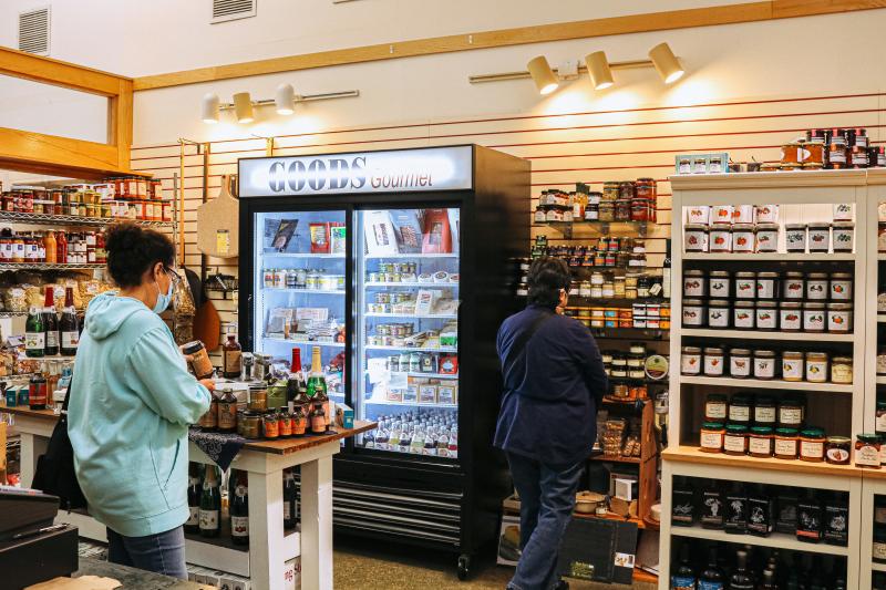 Two women shopping in the food market section of Goods for Cooks