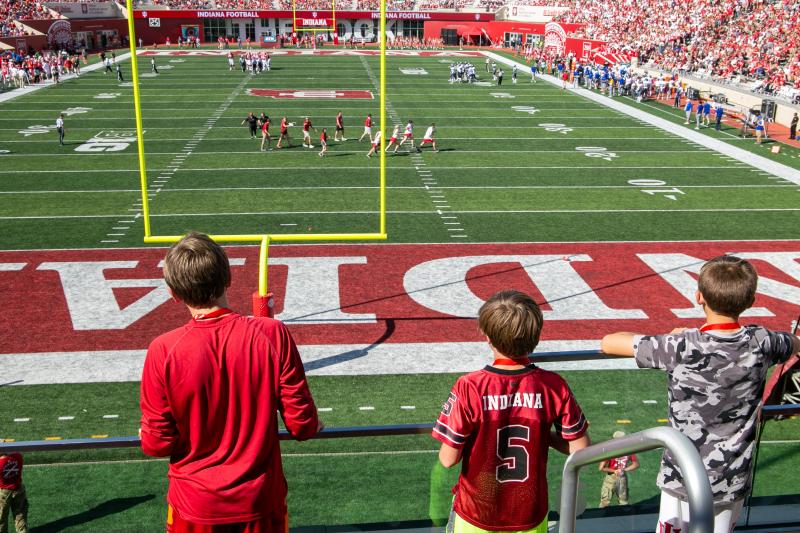 Three boys watching an IU football game at Memorial Stadium