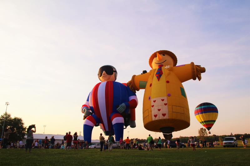 Three hot air balloons launching at the Indiana Kiwanis Balloon Festival