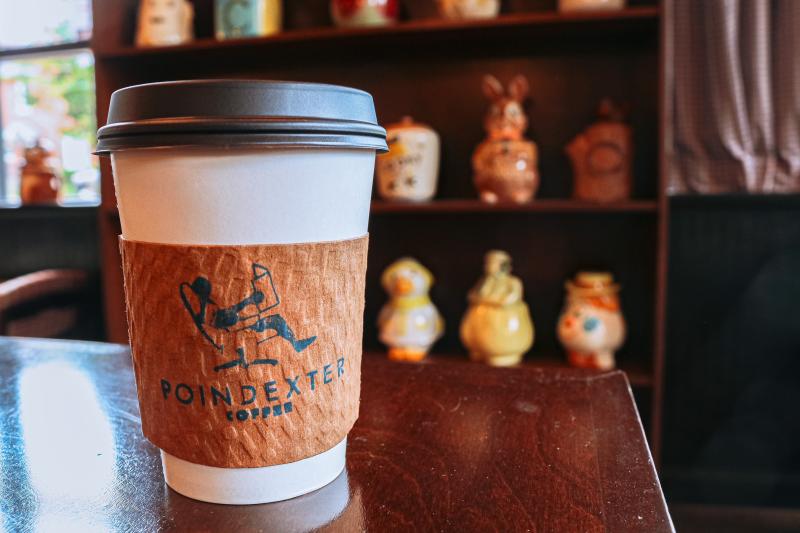 A to-go latte from Poindexter Coffee