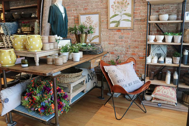 Display of home accents and clothing at Lola + Co.