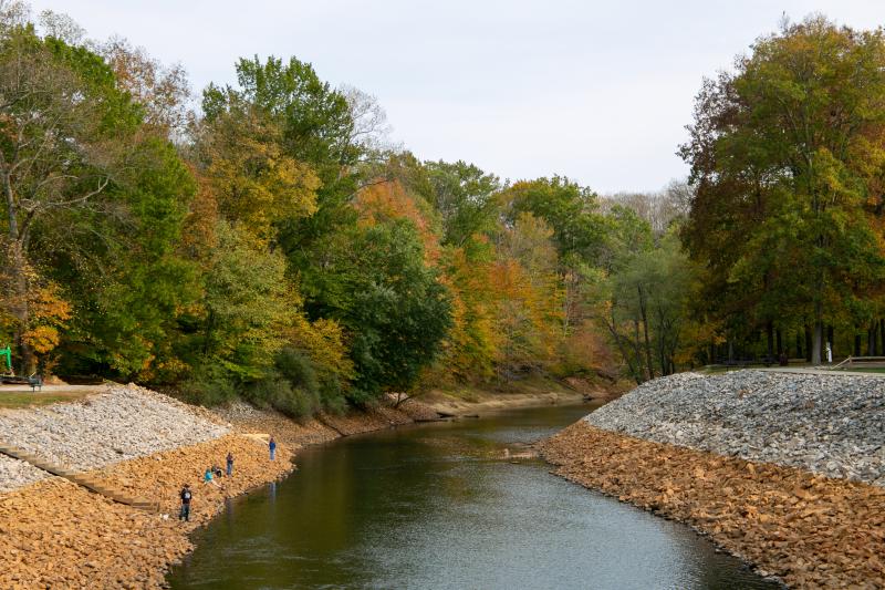 People fishing at the Monroe Lake Spillway during fall