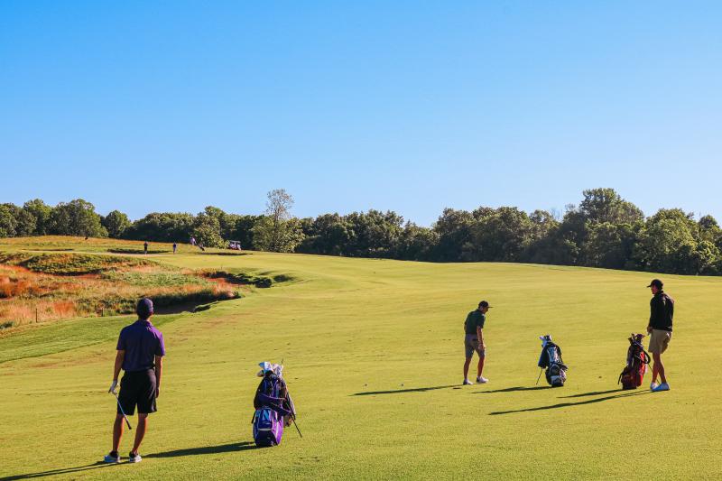 Three men playing golf at The Pfau Course at Indiana University