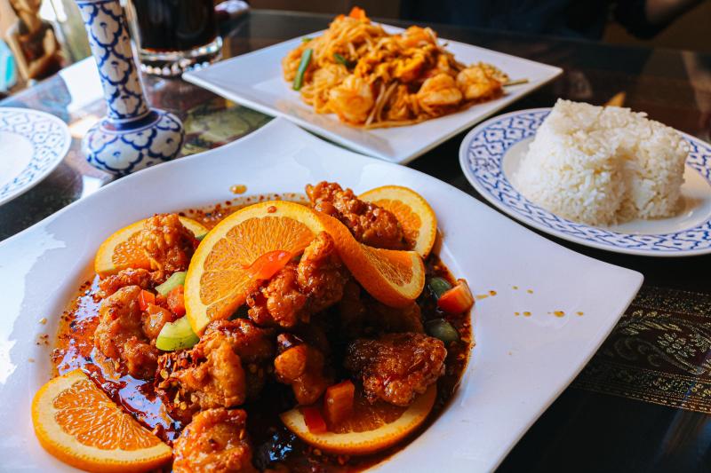 A plate of orange chicken and pad Thai from Siam House