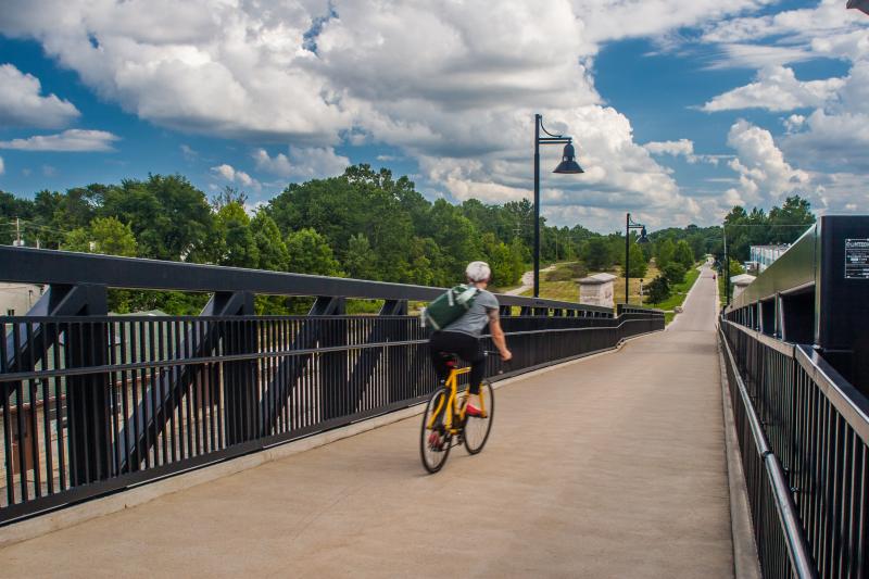 A cyclist pedals along the B-Line trail in Bloomington, IN.